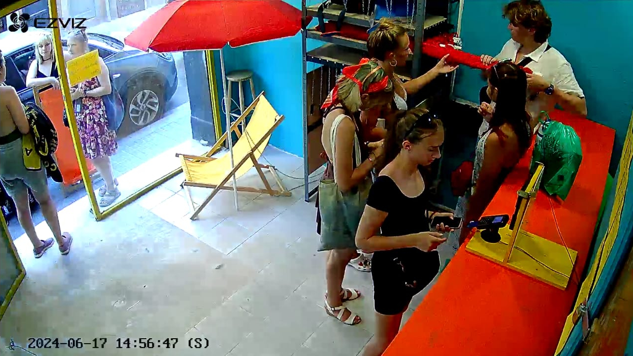 Multiple customers browsing and using the automated rental system to select beach equipment