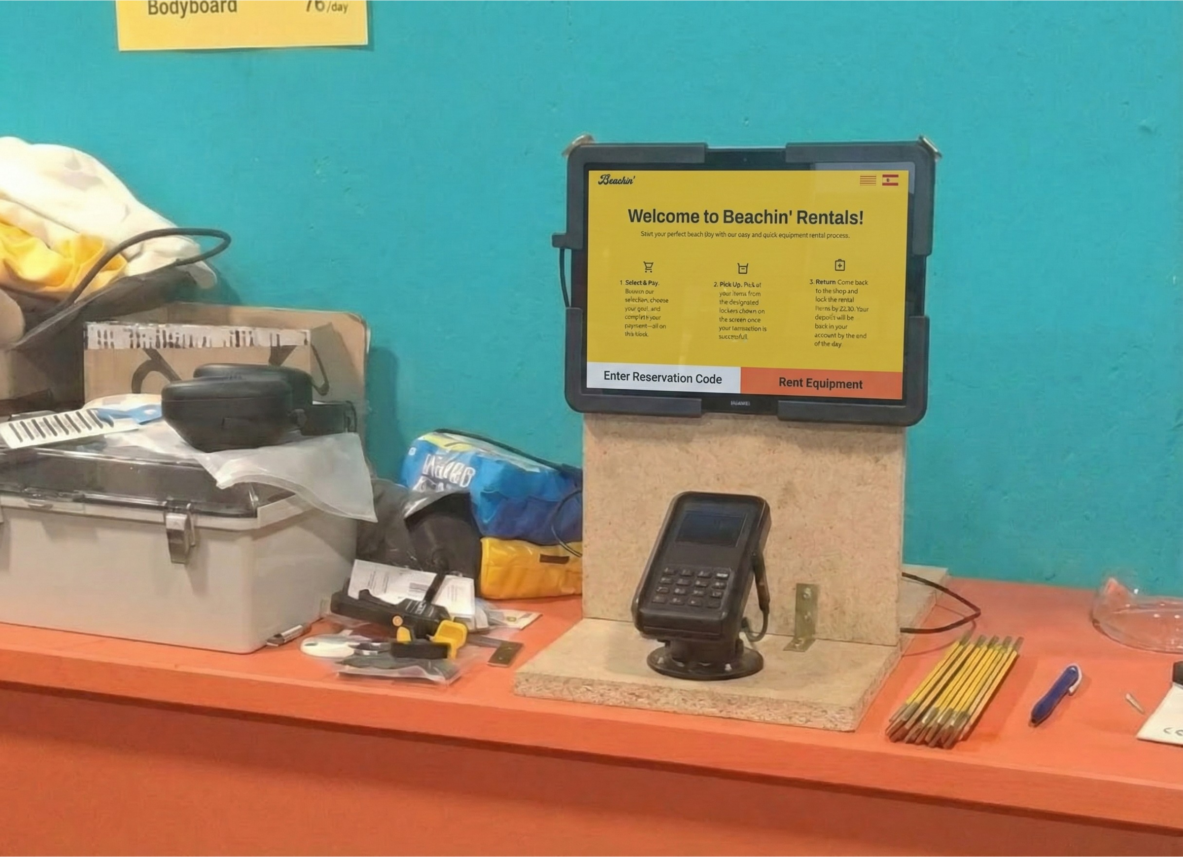 Self-service kiosk with touchscreen interface for product selection and integrated payment terminal for rental equipment